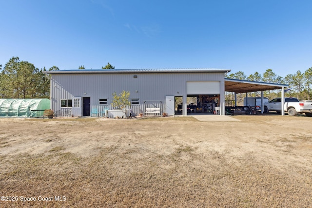 view of outdoor structure with a garage and a carport