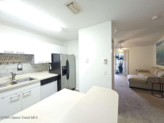 kitchen with sink, white cabinetry, stainless steel fridge with ice dispenser, white dishwasher, and backsplash