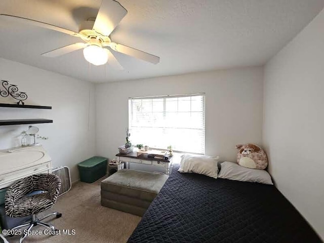 bedroom with ceiling fan and light carpet