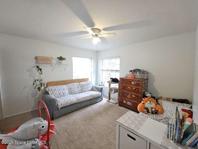 carpeted living room featuring ceiling fan