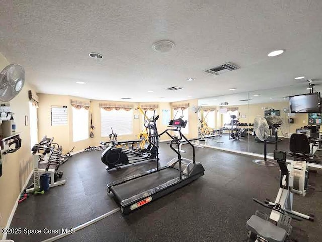 exercise room featuring a textured ceiling