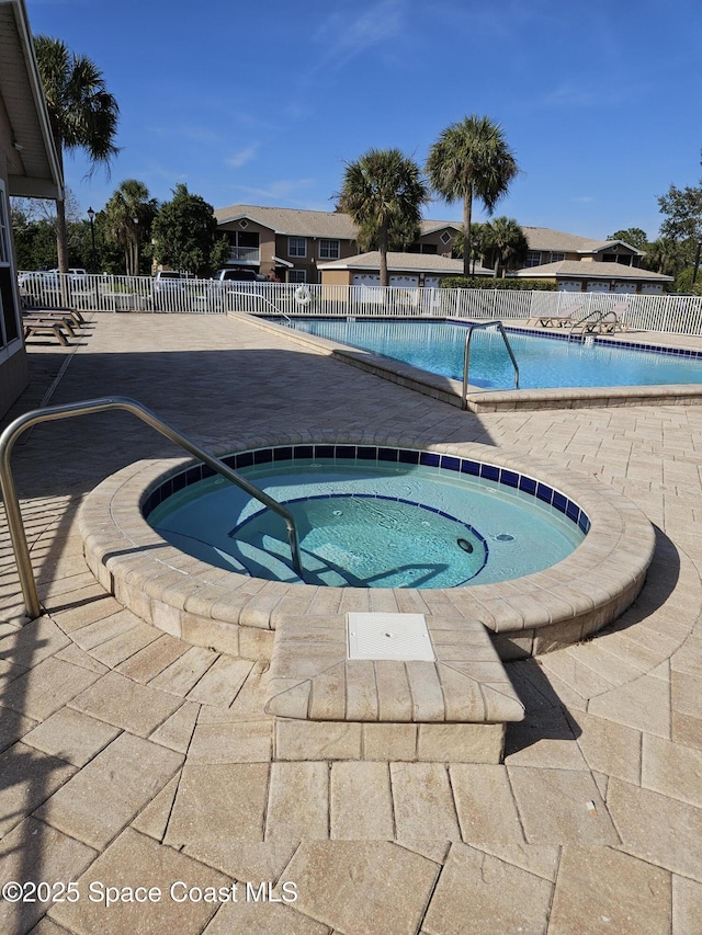 view of pool with a hot tub