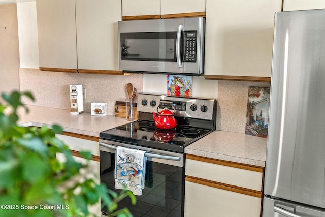 kitchen featuring appliances with stainless steel finishes and backsplash