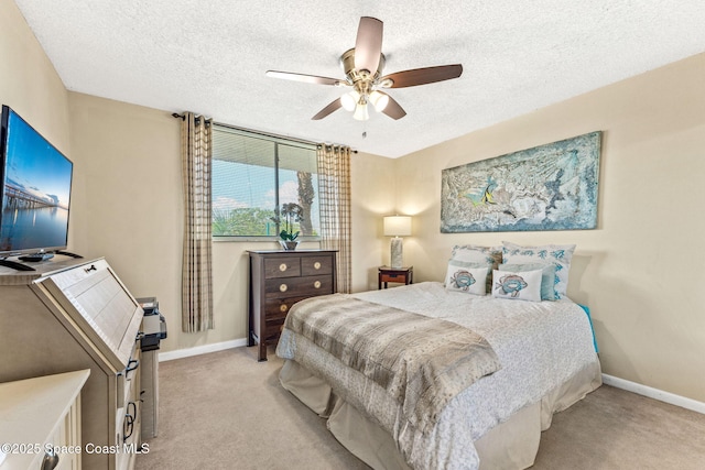 bedroom featuring light carpet, a textured ceiling, and baseboards