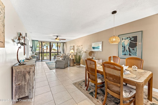 dining room with light tile patterned floors, a textured ceiling, a ceiling fan, and baseboards