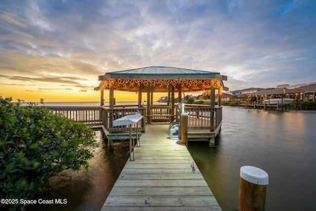 view of dock with a gazebo and a water view