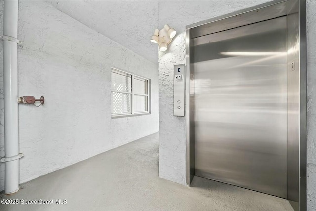 interior space featuring concrete floors and elevator