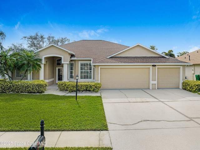 single story home with a front yard, a shingled roof, stucco siding, concrete driveway, and a garage