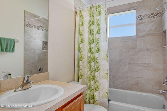 full bathroom with vanity, shower / tub combo, and toilet