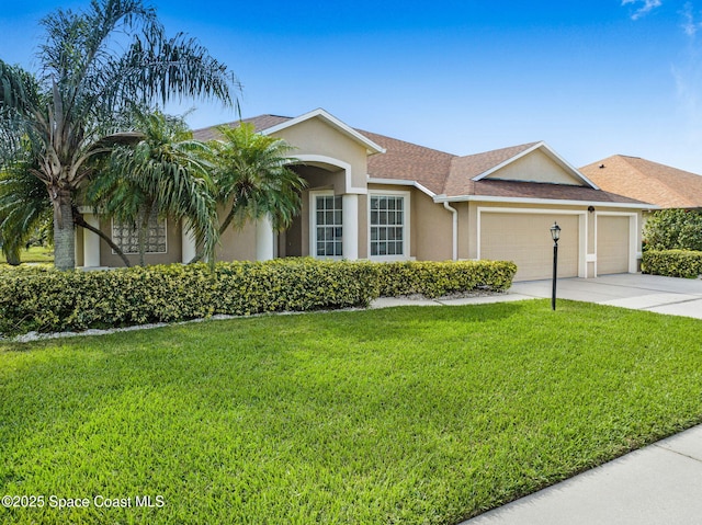 ranch-style house with a garage and a front lawn