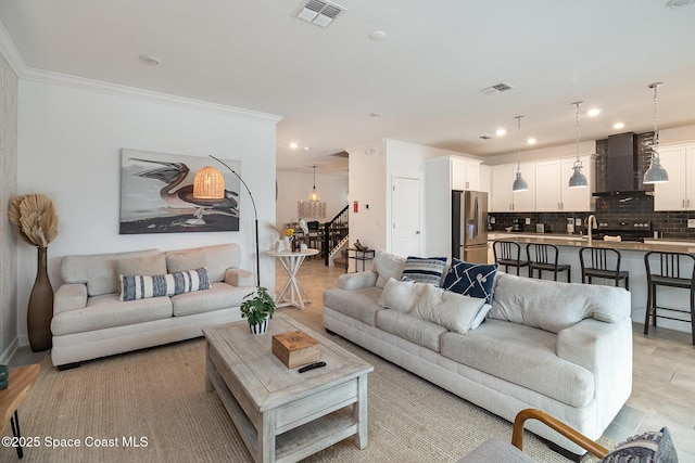 living room featuring sink and ornamental molding