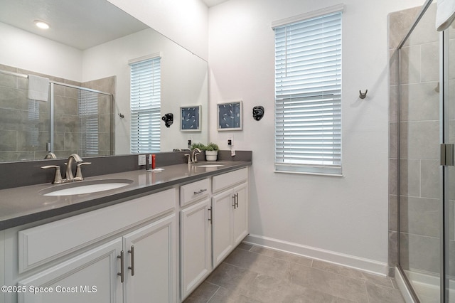 bathroom with tile patterned floors, an enclosed shower, and vanity