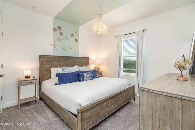 carpeted bedroom with an inviting chandelier