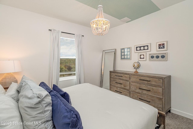 bedroom with carpet and a chandelier