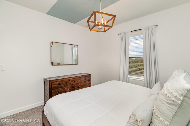 carpeted bedroom with an inviting chandelier