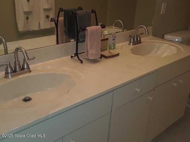 bathroom featuring toilet and vanity