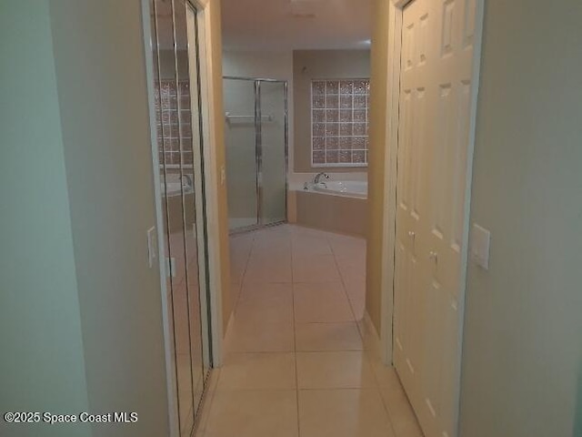 corridor featuring light tile patterned flooring