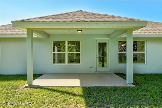 back of property featuring a patio area and a yard