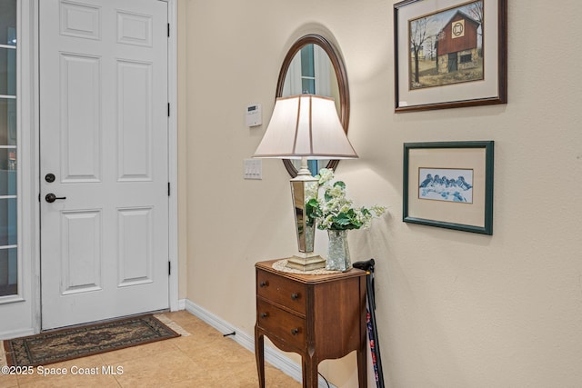 entryway with light tile patterned floors