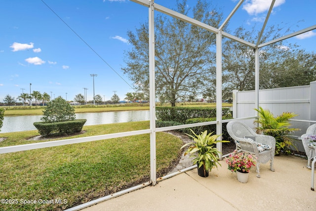 unfurnished sunroom with a water view