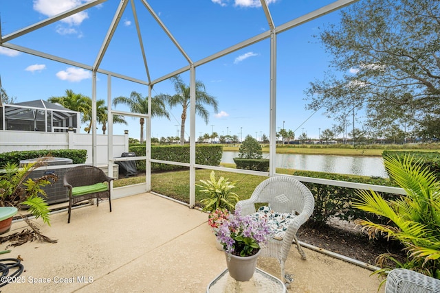 sunroom / solarium featuring a water view