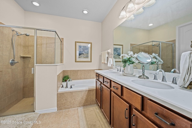 bathroom with independent shower and bath, tile patterned flooring, and vanity