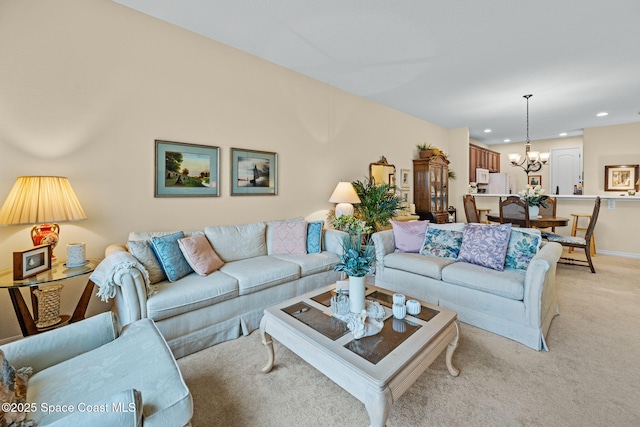 carpeted living room with a chandelier