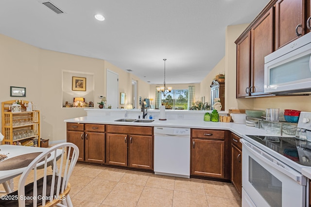 kitchen featuring decorative light fixtures, a notable chandelier, sink, white appliances, and light tile patterned floors