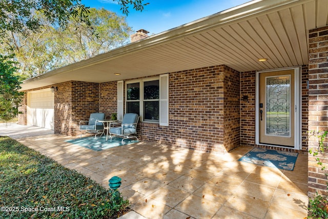 view of patio / terrace featuring a garage