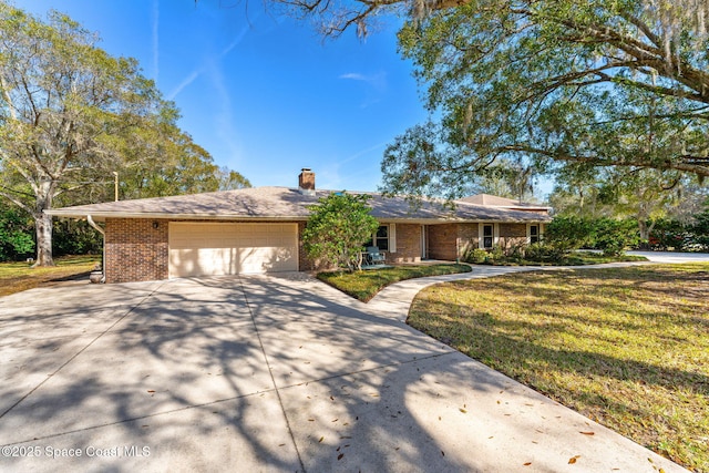 single story home with a garage and a front lawn