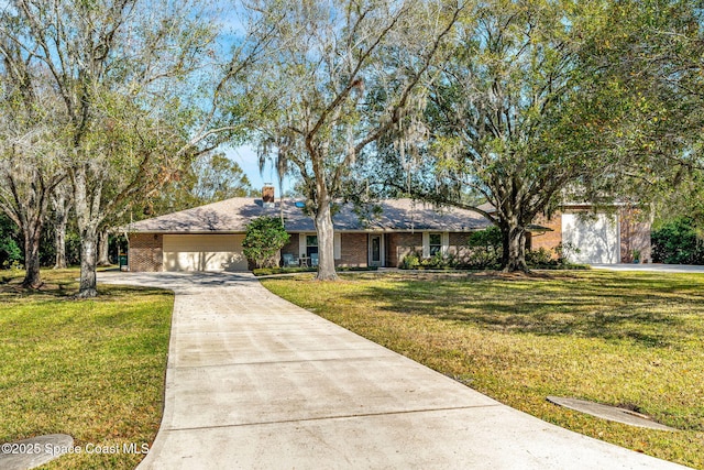 ranch-style home featuring a garage and a front yard