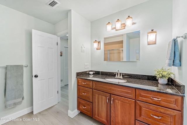 bathroom with vanity and wood-type flooring