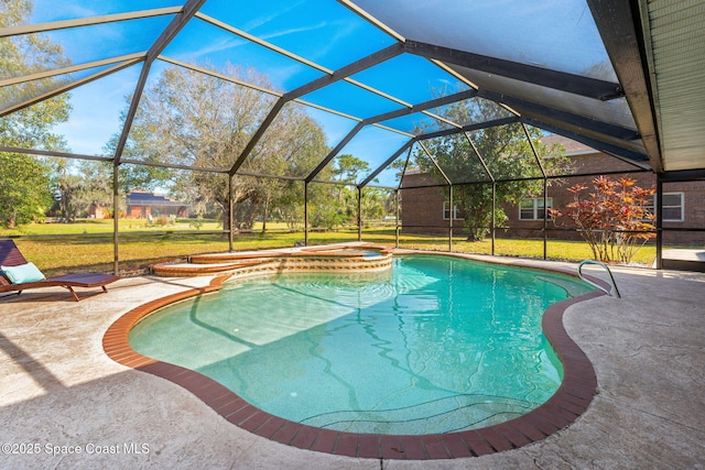 view of pool featuring a yard, a lanai, a patio area, and an in ground hot tub