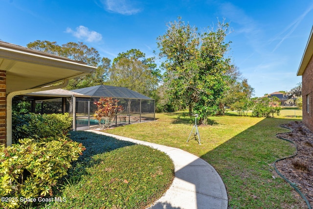 view of yard featuring glass enclosure