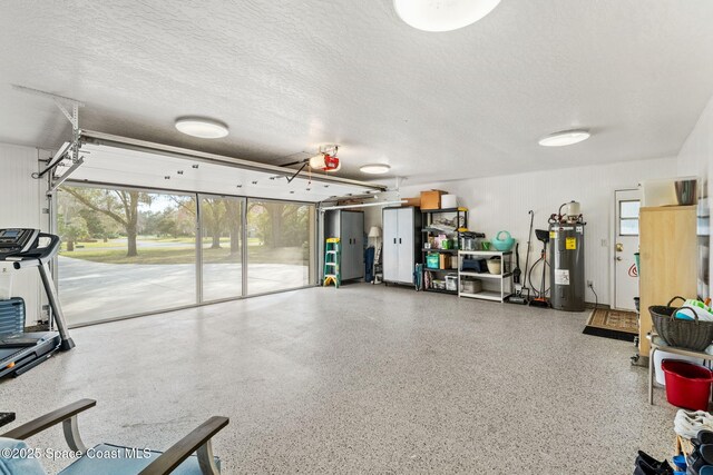 exercise room with electric water heater and a textured ceiling