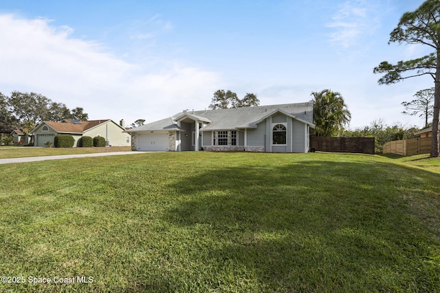 single story home with an attached garage, driveway, fence, and a front yard