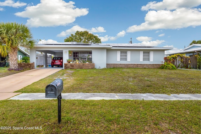 ranch-style house featuring a front yard and a carport