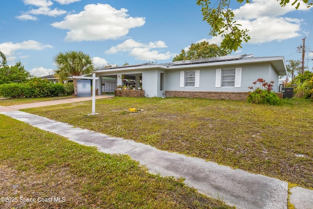 single story home with solar panels, a carport, and a front lawn