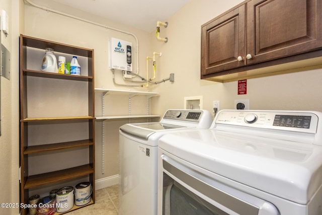 clothes washing area featuring cabinets, light tile patterned floors, and independent washer and dryer