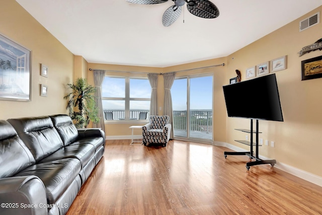 living room with ceiling fan and wood-type flooring