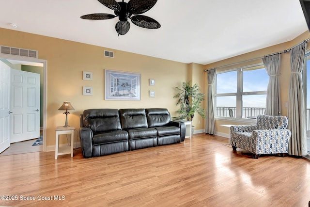 living room featuring ceiling fan and light wood-type flooring