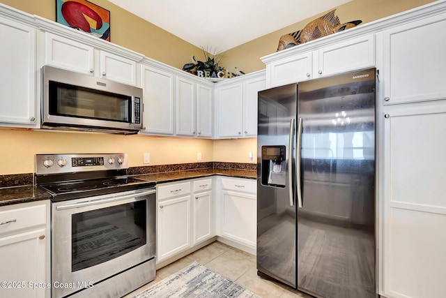 kitchen featuring stainless steel appliances and white cabinets