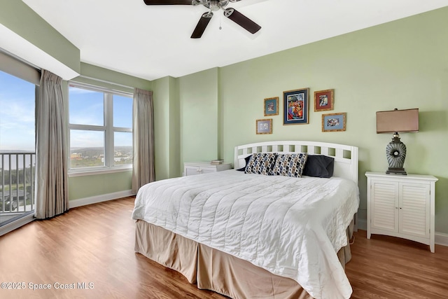 bedroom with ceiling fan and light hardwood / wood-style floors