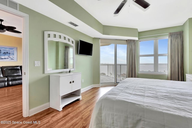 bedroom with ceiling fan, access to outside, and light hardwood / wood-style floors