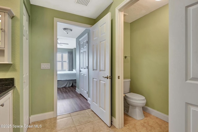 bathroom featuring tile patterned flooring, vanity, and toilet