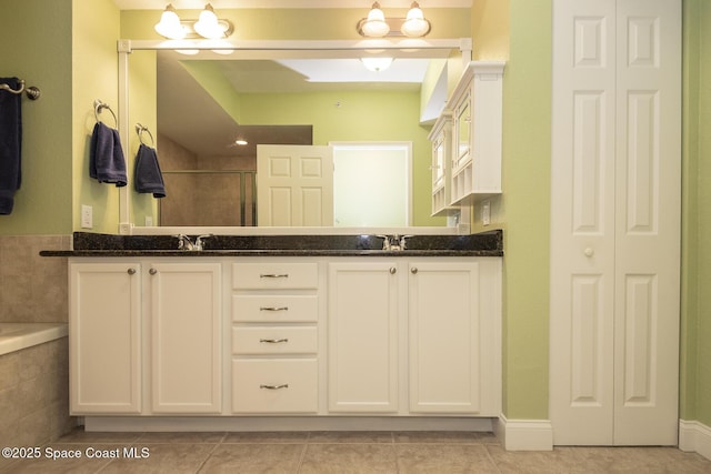 bathroom featuring tile patterned flooring, vanity, and an enclosed shower