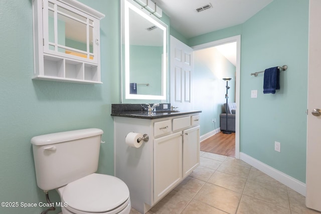 bathroom with vanity, tile patterned floors, and toilet