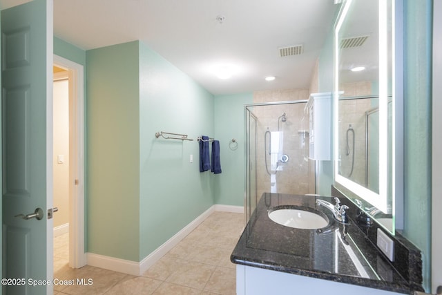 bathroom with vanity, an enclosed shower, and tile patterned floors