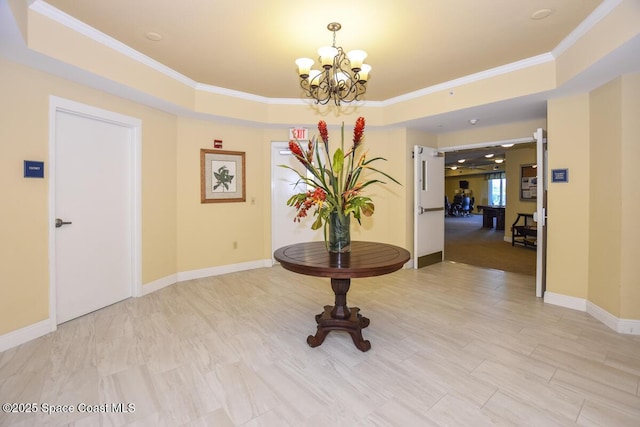 hall featuring a raised ceiling, crown molding, and a chandelier