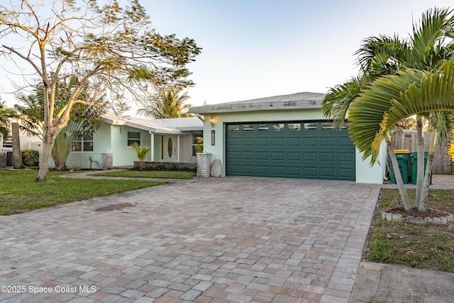 view of front facade with a garage and a front lawn